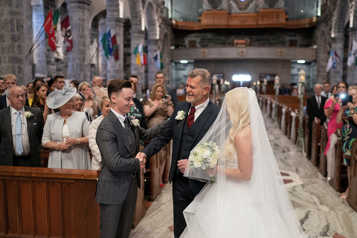 Galway Cathedral wedding photo of a groom seeing his bride for the first time before getting married